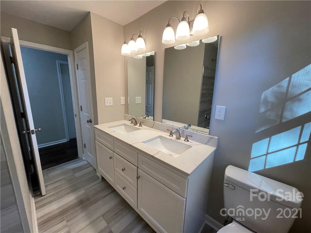 1601 Rushing Street Monroe, NC 28112 - Photo 15 of 21 a bathroom with a double vanity sink mirror and shower