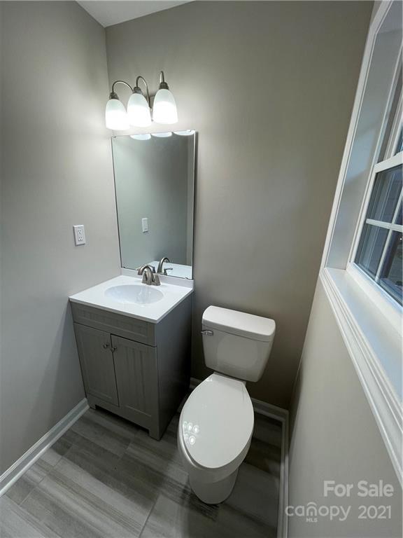 1601 Rushing Street Monroe, NC 28112 - Photo 19 of 21 a bathroom with a toilet sink and mirror