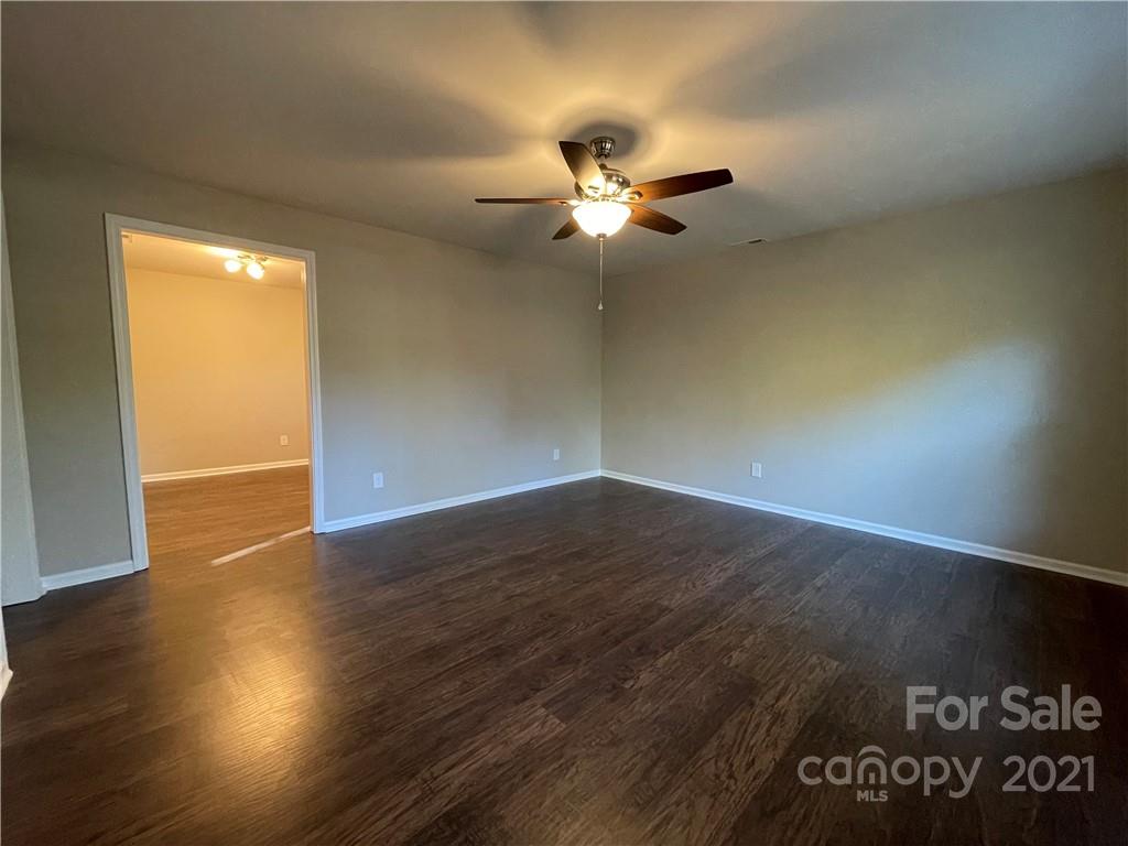 1601 Rushing Street Monroe, NC 28112 - Photo 6 of 21 an empty room with wooden floor fan and windows