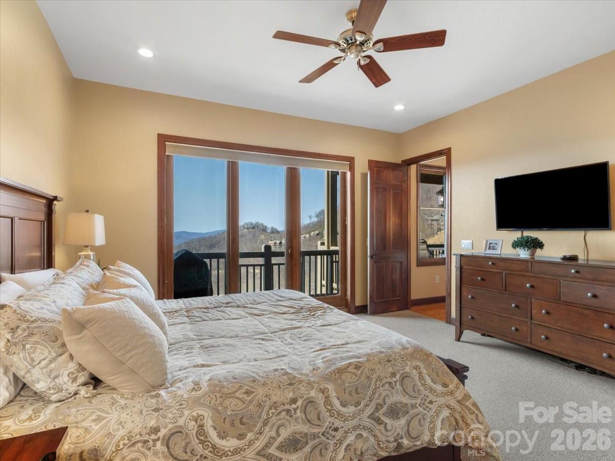 600 Andrew Banks Road, Unit D4 Burnsville, NC 28714 - Photo 26 of 42 a bedroom with a bed and a flat screen tv