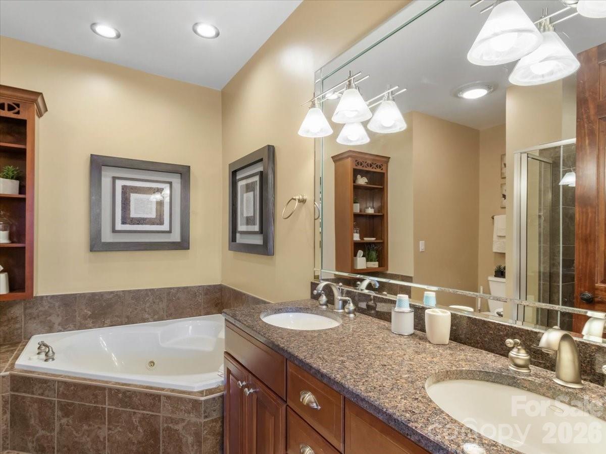 600 Andrew Banks Road, Unit D4 Burnsville, NC 28714 - Photo 27 of 42 a bathroom with a granite countertop sink and a bathtub