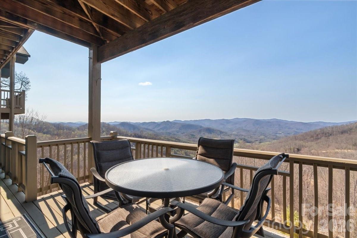 600 Andrew Banks Road, Unit D4 Burnsville, NC 28714 - Photo 33 of 42 a view of a balcony with a table and chairs