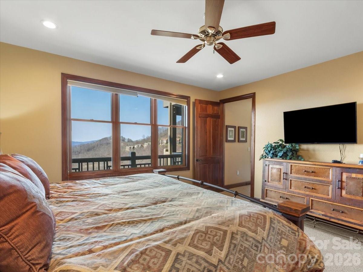 600 Andrew Banks Road, Unit D4 Burnsville, NC 28714 - Photo 35 of 42 a bedroom with a bed and a flat screen tv