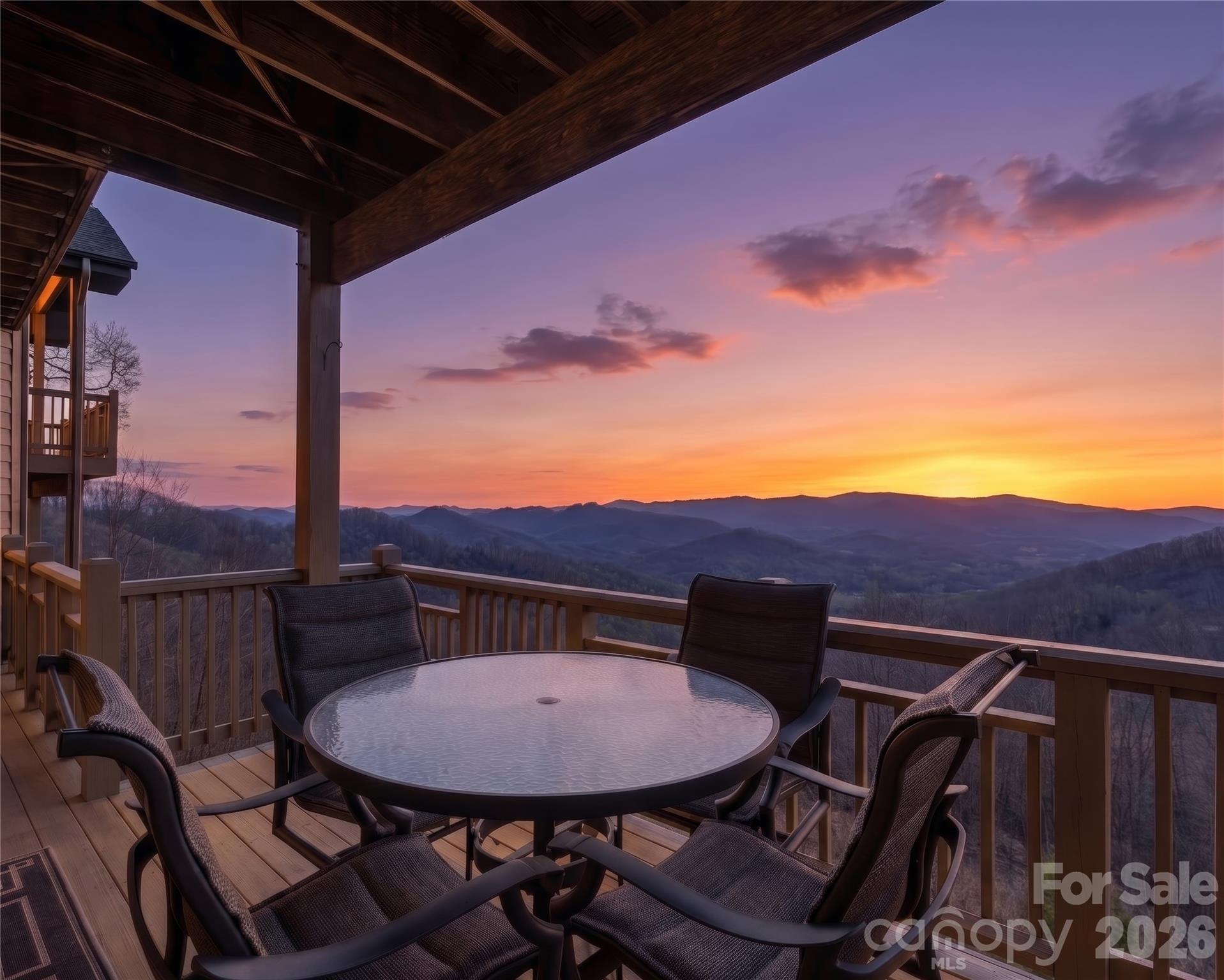 600 Andrew Banks Road, Unit D4 Burnsville, NC 28714 - Photo 42 of 42 a view of a balcony with a table and chairs