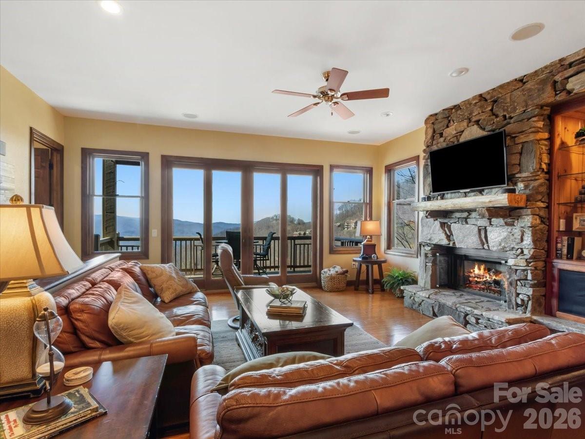 600 Andrew Banks Road, Unit D4 Burnsville, NC 28714 - Photo 5 of 42 a living room with furniture a fireplace and a flat screen tv