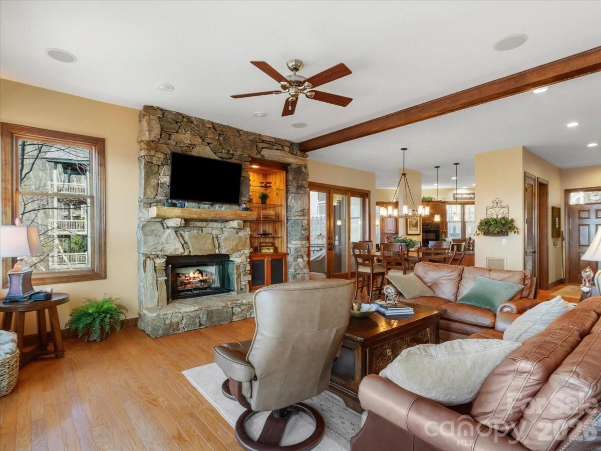 600 Andrew Banks Road, Unit D4 Burnsville, NC 28714 - Photo 7 of 42 a living room with furniture a fireplace and a flat screen tv