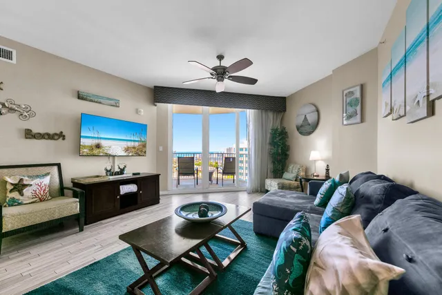 a living room with furniture a chandelier and a window