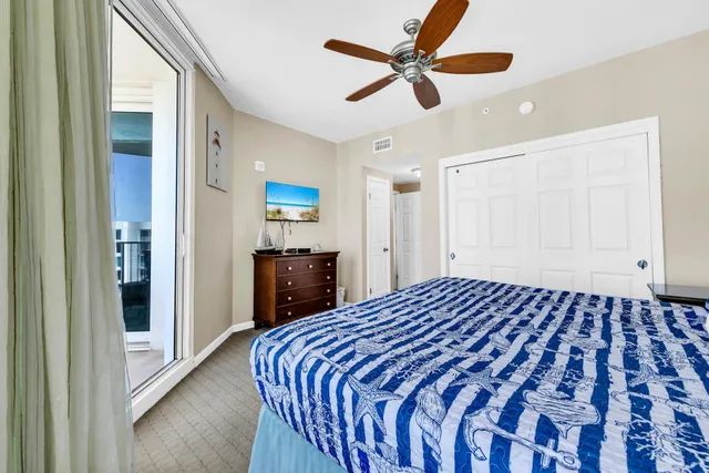 a bedroom with a large bed and a chandelier