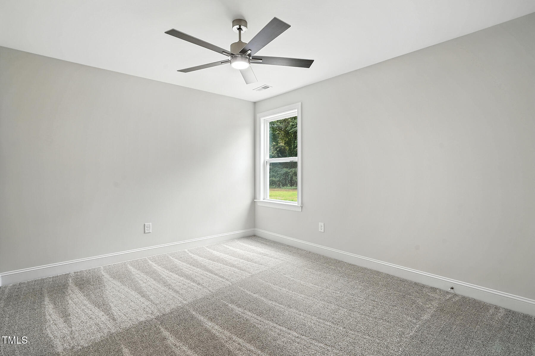 8686 Green Path Road Dunn, NC 28334 - Photo 18 of 31 an empty room with a window and a fan
