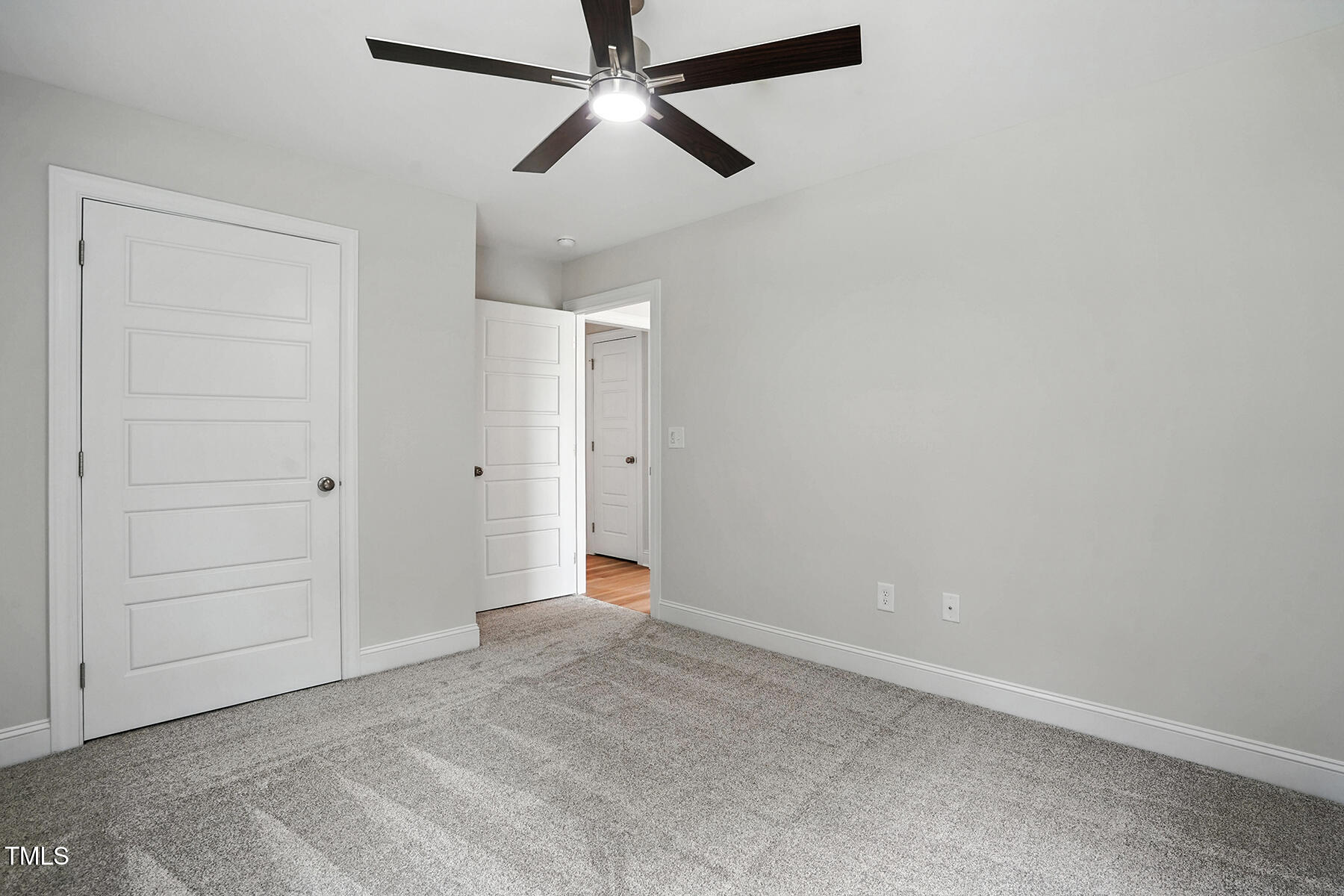 8686 Green Path Road Dunn, NC 28334 - Photo 19 of 31 an empty room with closet and a chandelier fan