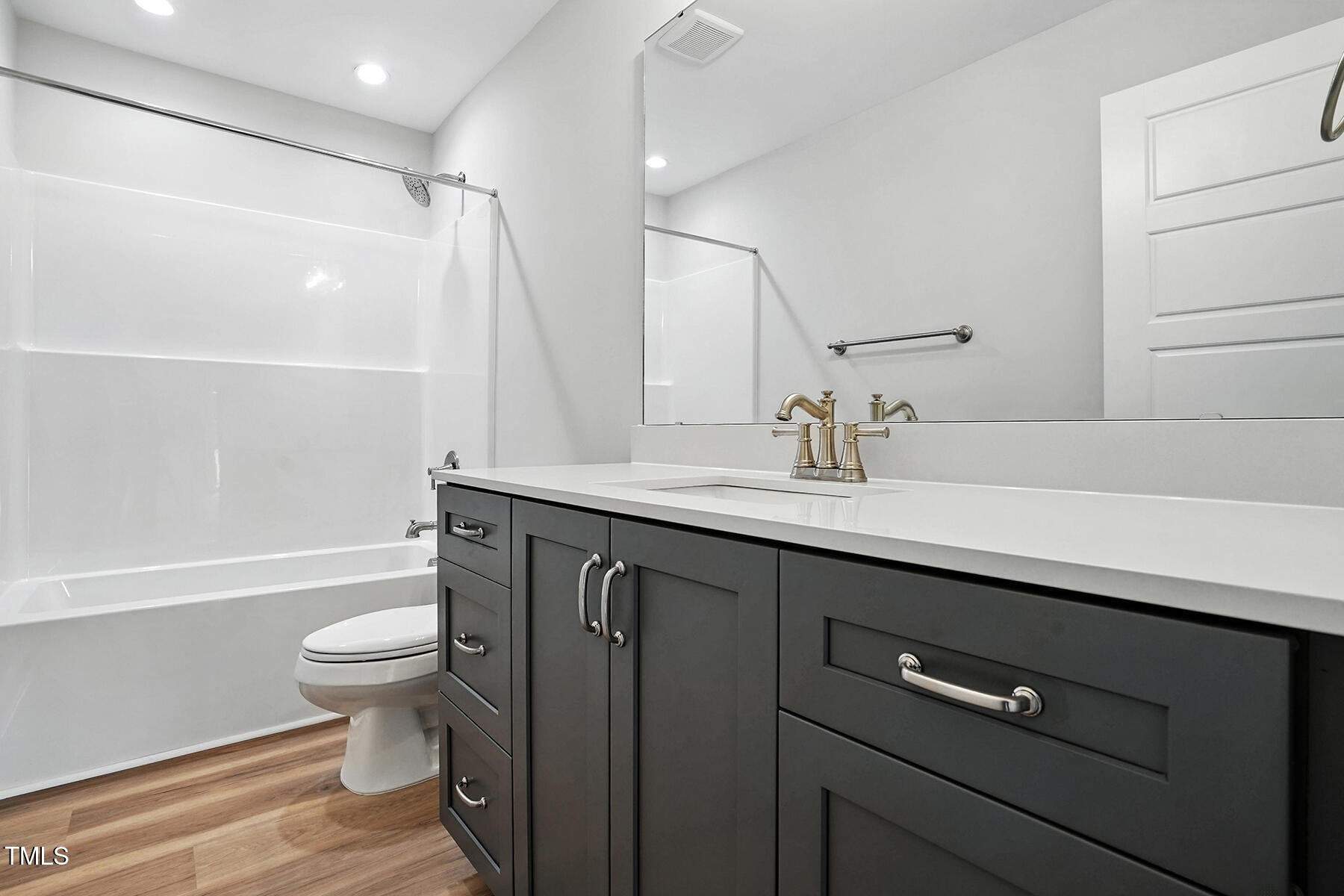 8686 Green Path Road Dunn, NC 28334 - Photo 20 of 31 a bathroom with a sink a toilet a large mirror and shower