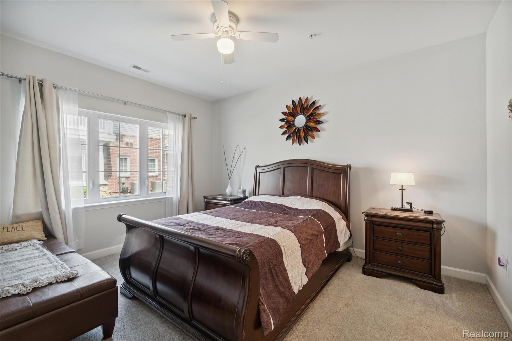 5662 Arbor Chase Drive Ann Arbor, MI 48103 - Photo 19 of 27 Bedroom featuring carpet flooring, a white ceiling fan with integrated lighting, and multiple windows with white trim