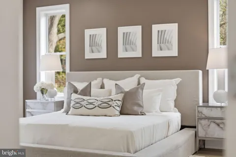 a bedroom with a bed and a painting
