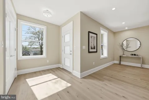 a living room with fireplace furniture and a wooden floor