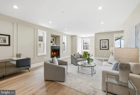 a dining room with furniture and kitchen view