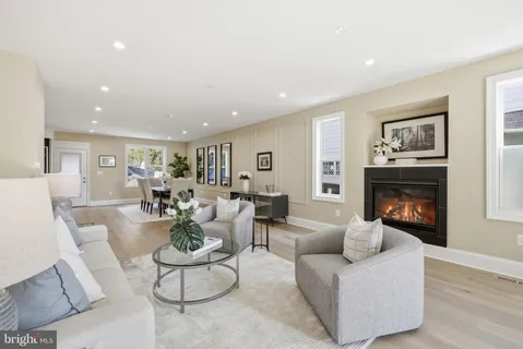 a kitchen with stainless steel appliances kitchen island granite countertop a stove a sink a oven and a dining table with wooden floor