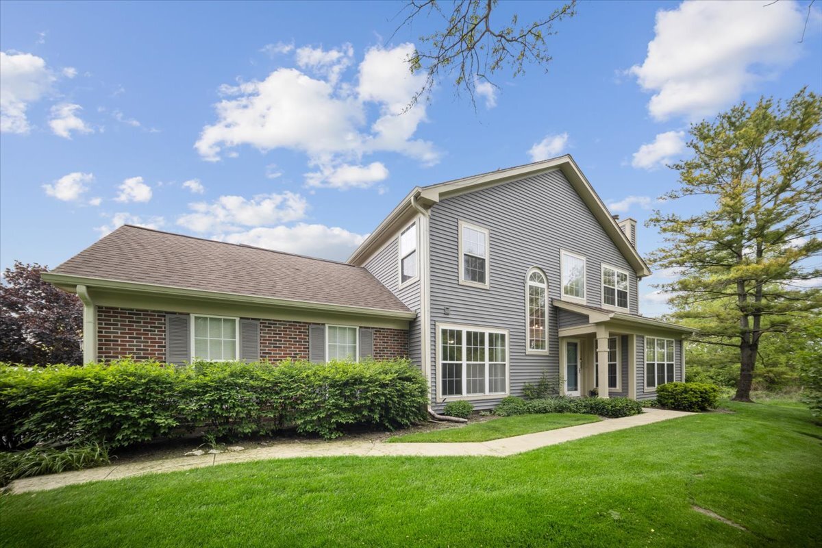 1148 Coldspring Road Elgin, IL 60120 - Photo 1 of 27 a front view of a house with a garden
