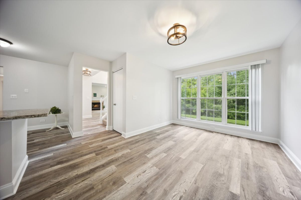 1148 Coldspring Road Elgin, IL 60120 - Photo 14 of 27 a view of empty room with wooden floor and fan
