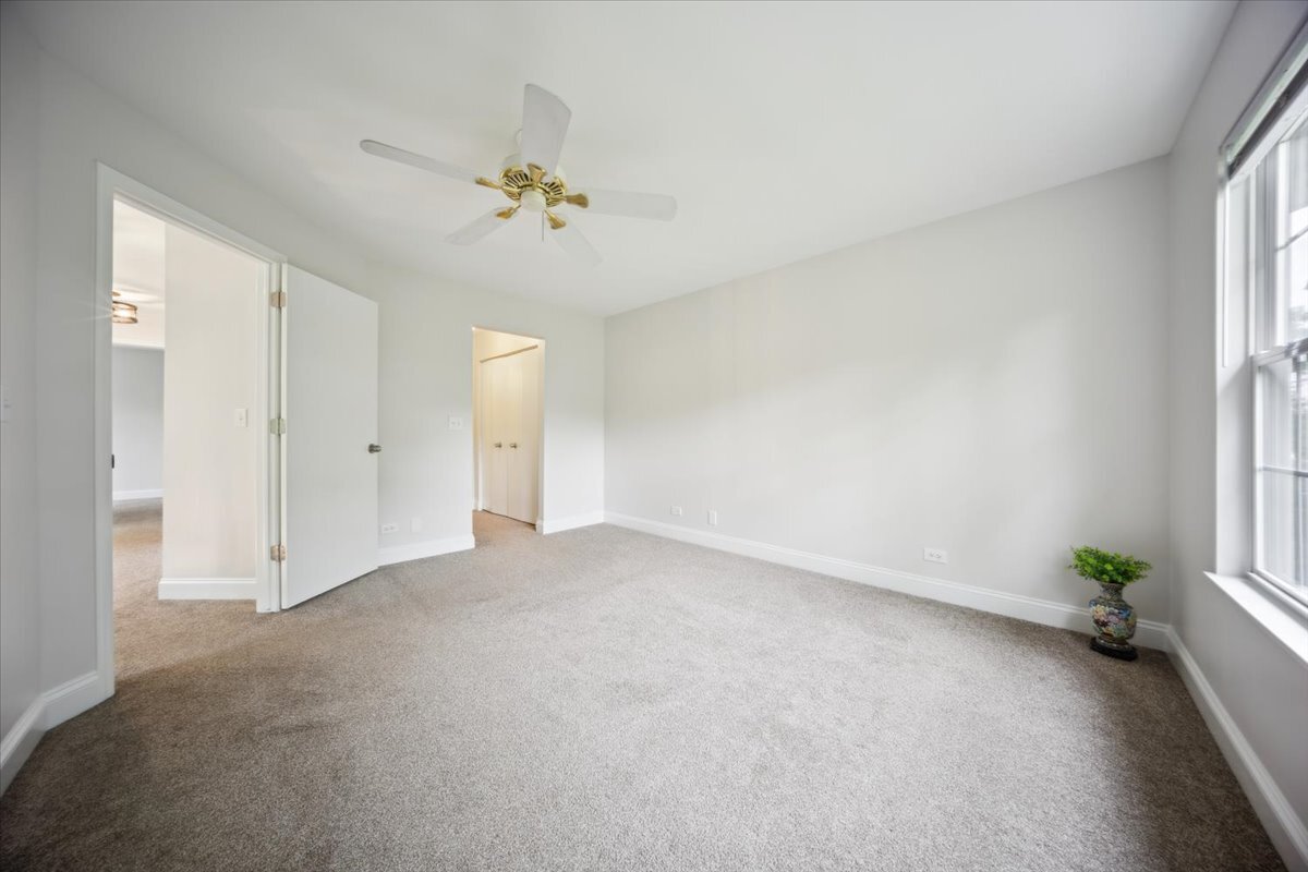 1148 Coldspring Road Elgin, IL 60120 - Photo 18 of 27 an empty room with a window and a chandelier fan