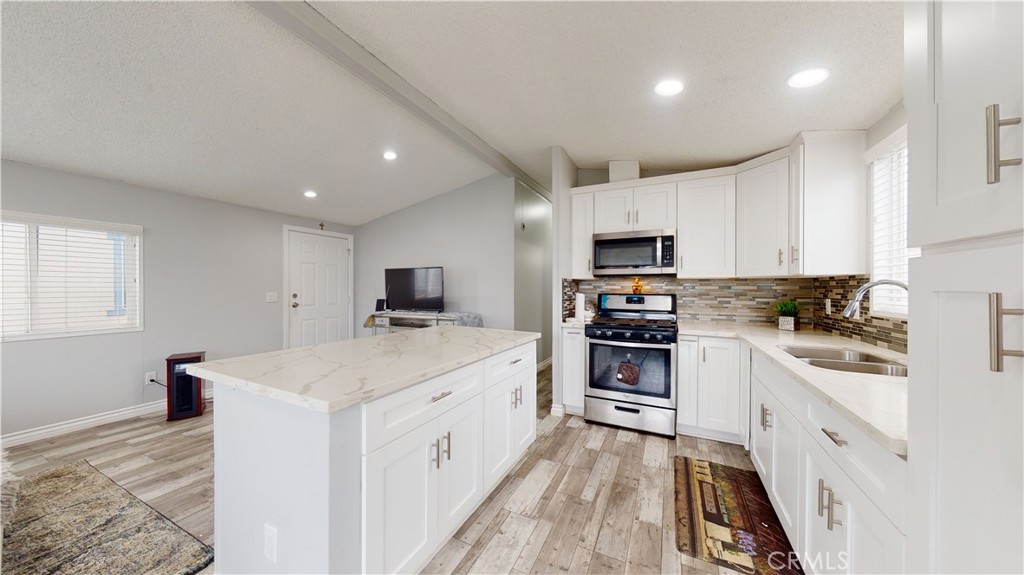 1782 Nisson Road, Unit 7 Tustin, CA 92780 - Photo 12 of 29 a kitchen with granite countertop a sink stove and refrigerator