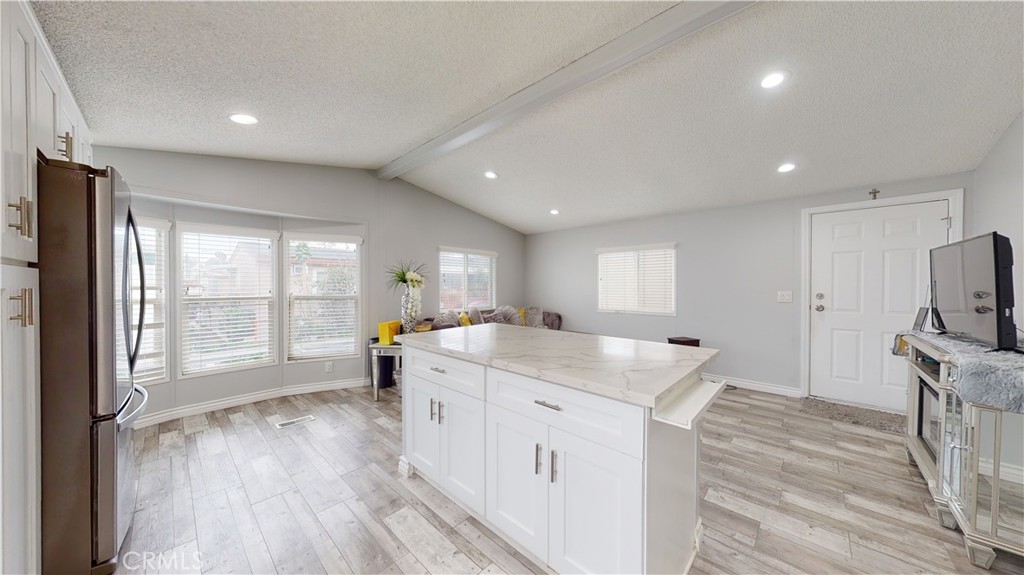1782 Nisson Road, Unit 7 Tustin, CA 92780 - Photo 14 of 29 a kitchen with stainless steel appliances granite countertop a sink stove and wooden floor