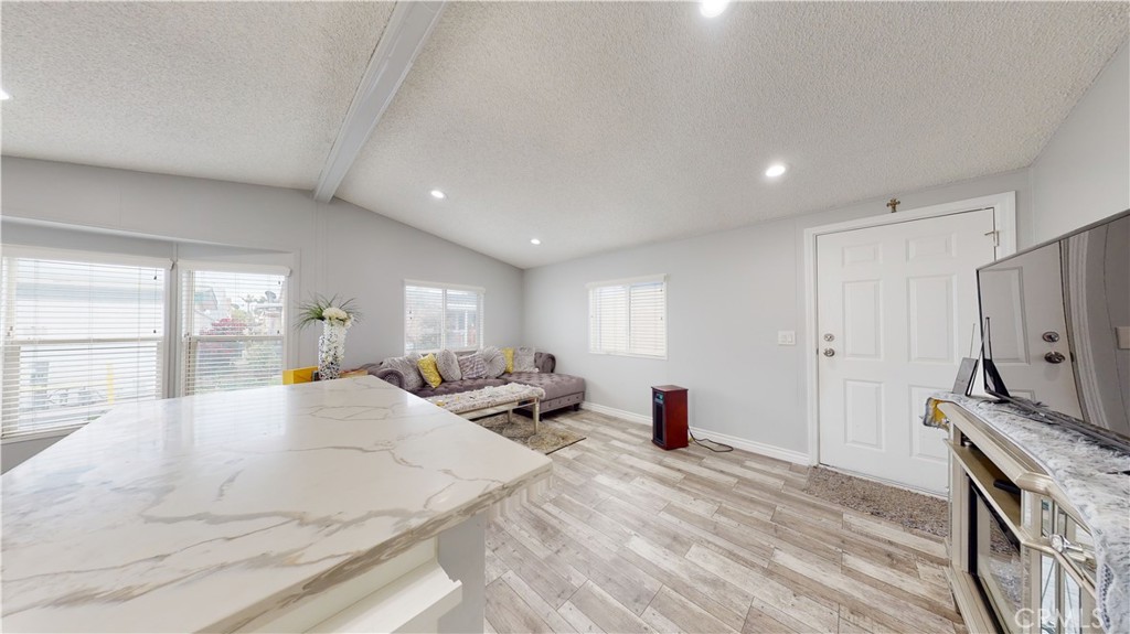 1782 Nisson Road, Unit 7 Tustin, CA 92780 - Photo 16 of 29 a large bedroom with a bed a window and a dresser