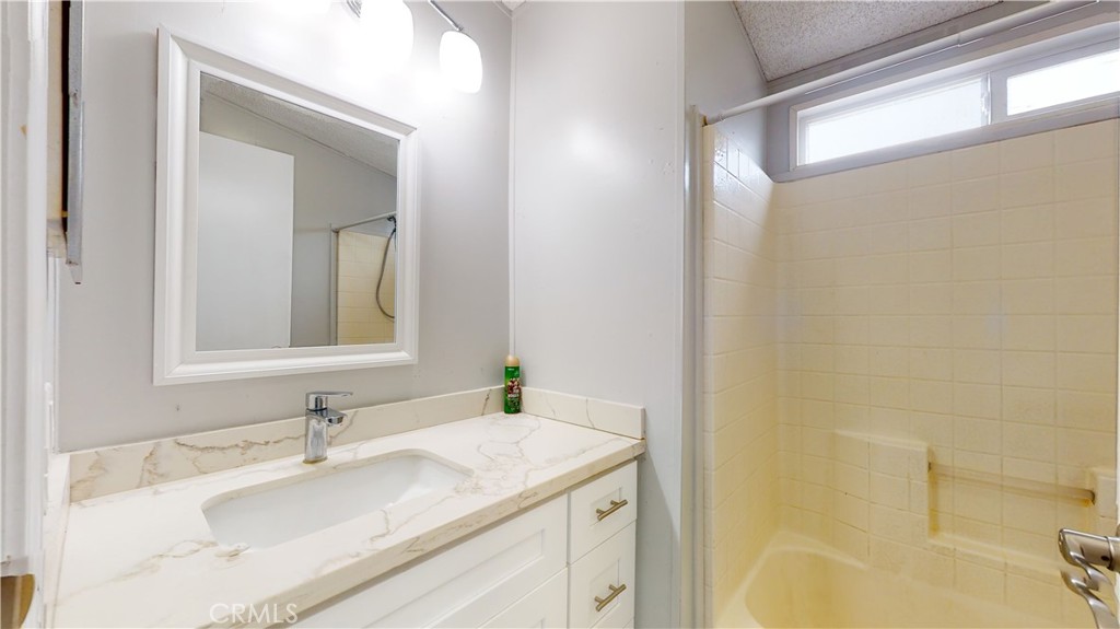 1782 Nisson Road, Unit 7 Tustin, CA 92780 - Photo 17 of 29 a bathroom with a granite countertop sink and a mirror