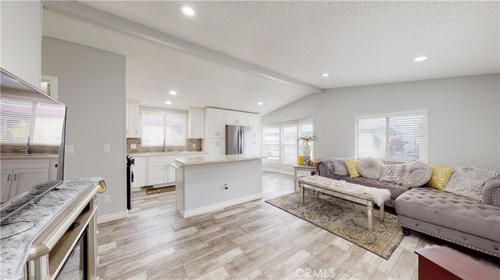 1782 Nisson Road, Unit 7 Tustin, CA 92780 - Photo 2 of 29 a living room with furniture and kitchen