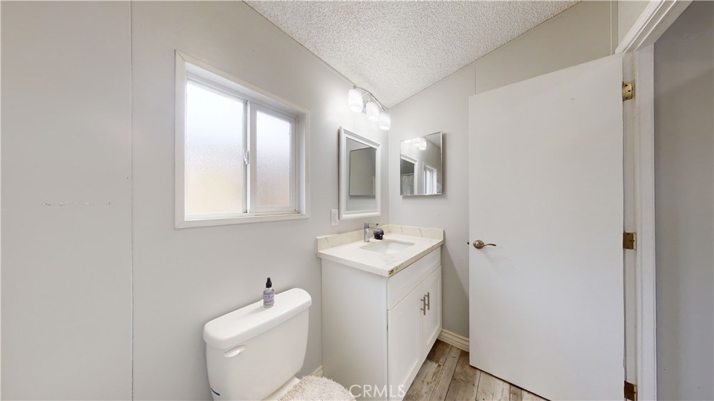 1782 Nisson Road, Unit 7 Tustin, CA 92780 - Photo 25 of 29 a bathroom with a toilet sink and mirror