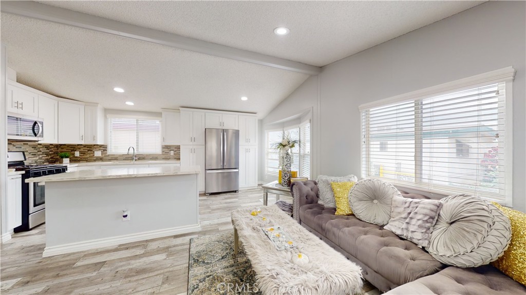 1782 Nisson Road, Unit 7 Tustin, CA 92780 - Photo 5 of 29 a living room with granite countertop furniture and a large window