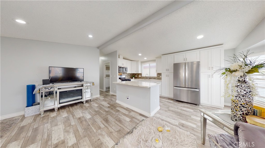 1782 Nisson Road, Unit 7 Tustin, CA 92780 - Photo 6 of 29 a kitchen with a refrigerator and a stove top oven