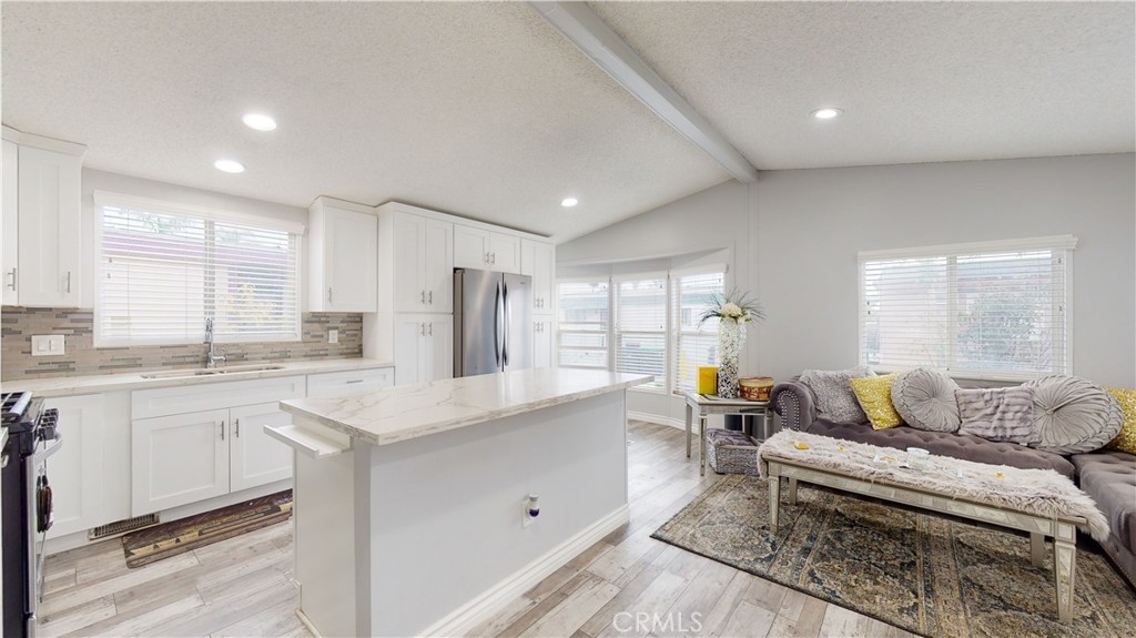 1782 Nisson Road, Unit 7 Tustin, CA 92780 - Photo 8 of 29 a living room with stainless steel appliances granite countertop furniture and a kitchen view