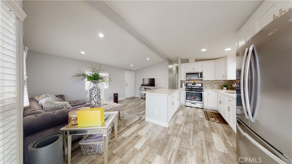 1782 Nisson Road, Unit 7 Tustin, CA 92780 - Photo 9 of 29 a living room with stainless steel appliances furniture and a kitchen view