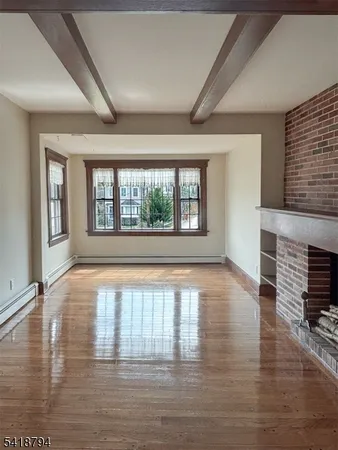 wooden floor in an empty room with a fireplace
