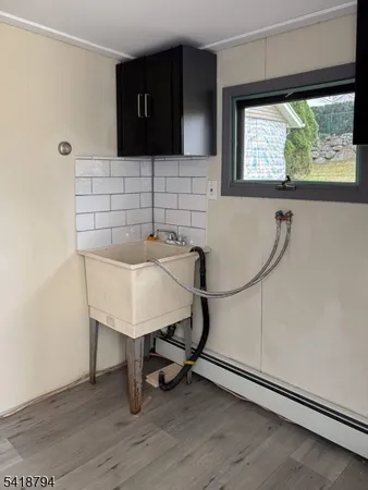 a room with a table chairs and a window