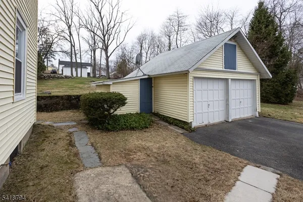 a view of a small house with a yard