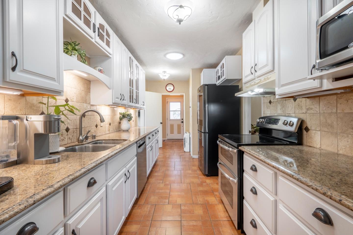545 4th Street Gilroy, CA 95020 - Photo 11 of 36 a large kitchen with stainless steel appliances granite countertop a sink stove and refrigerator