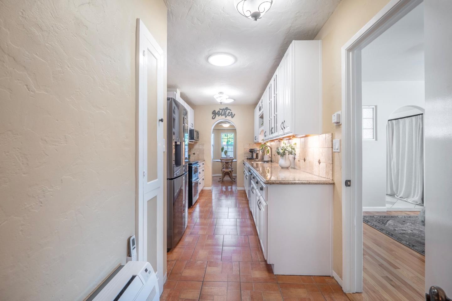 545 4th Street Gilroy, CA 95020 - Photo 12 of 36 a hallway view with wooden floor and a living room