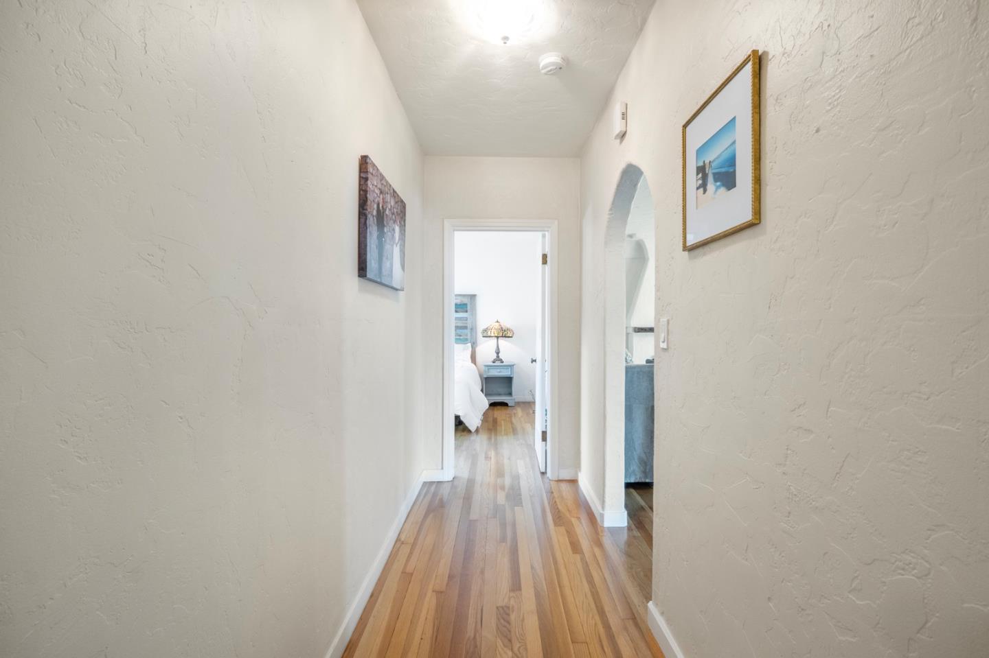 545 4th Street Gilroy, CA 95020 - Photo 15 of 36 a view of a hallway with wooden floor and a bathroom