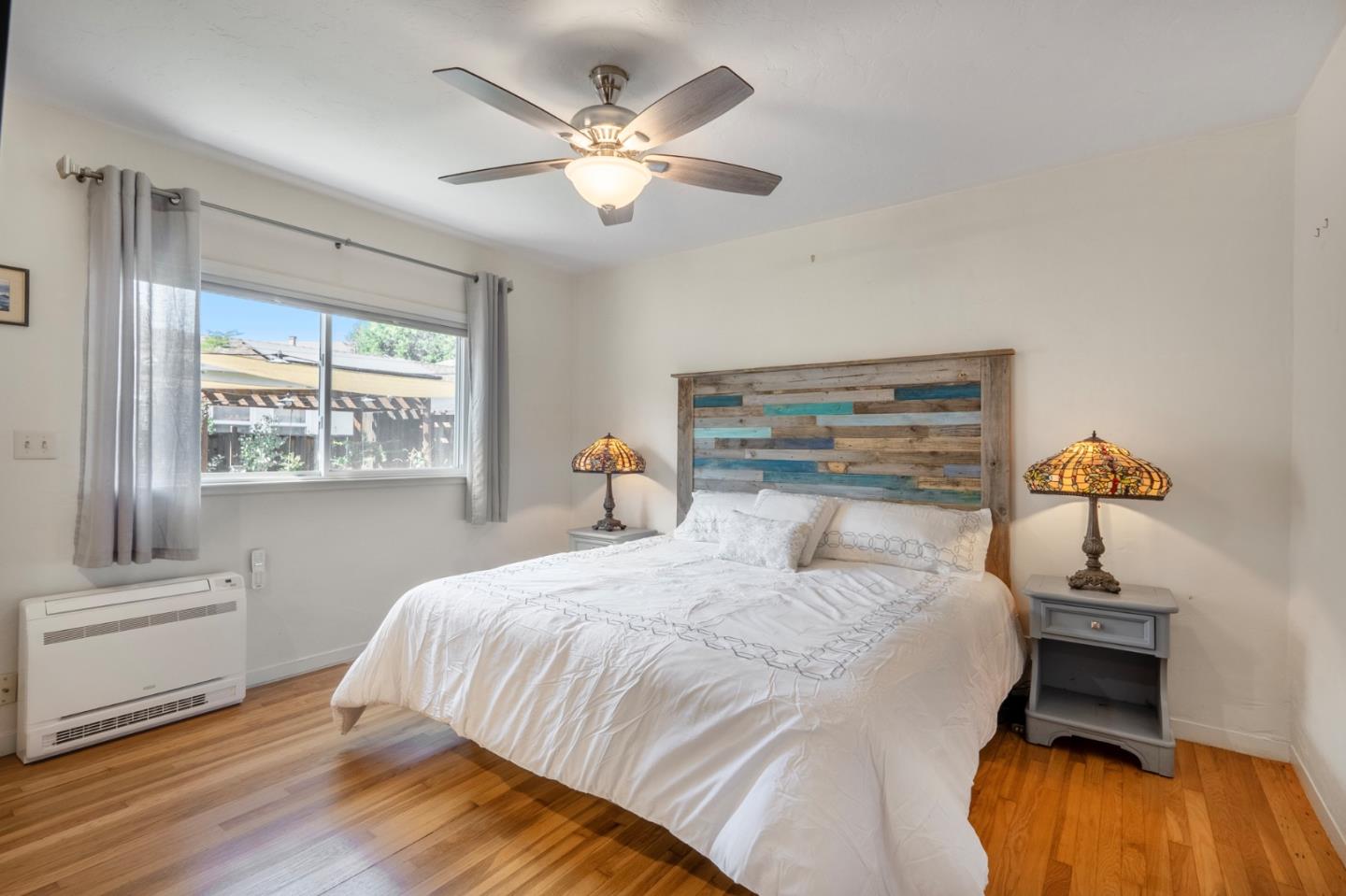 545 4th Street Gilroy, CA 95020 - Photo 16 of 36 a bedroom with a large bed and a chandelier