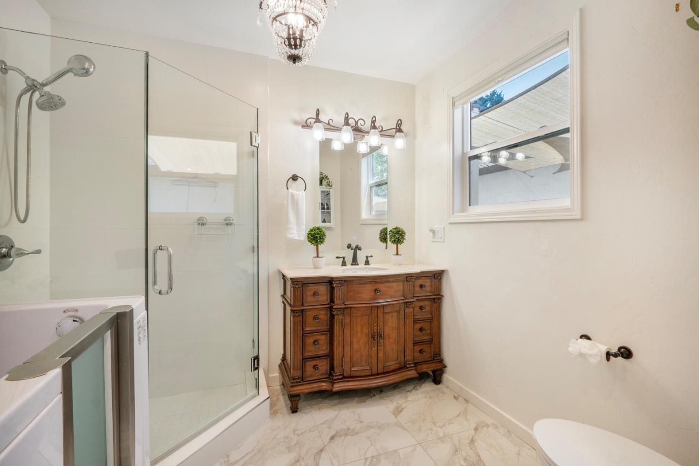 545 4th Street Gilroy, CA 95020 - Photo 18 of 36 a spacious bathroom with a double vanity sink mirror and toilet