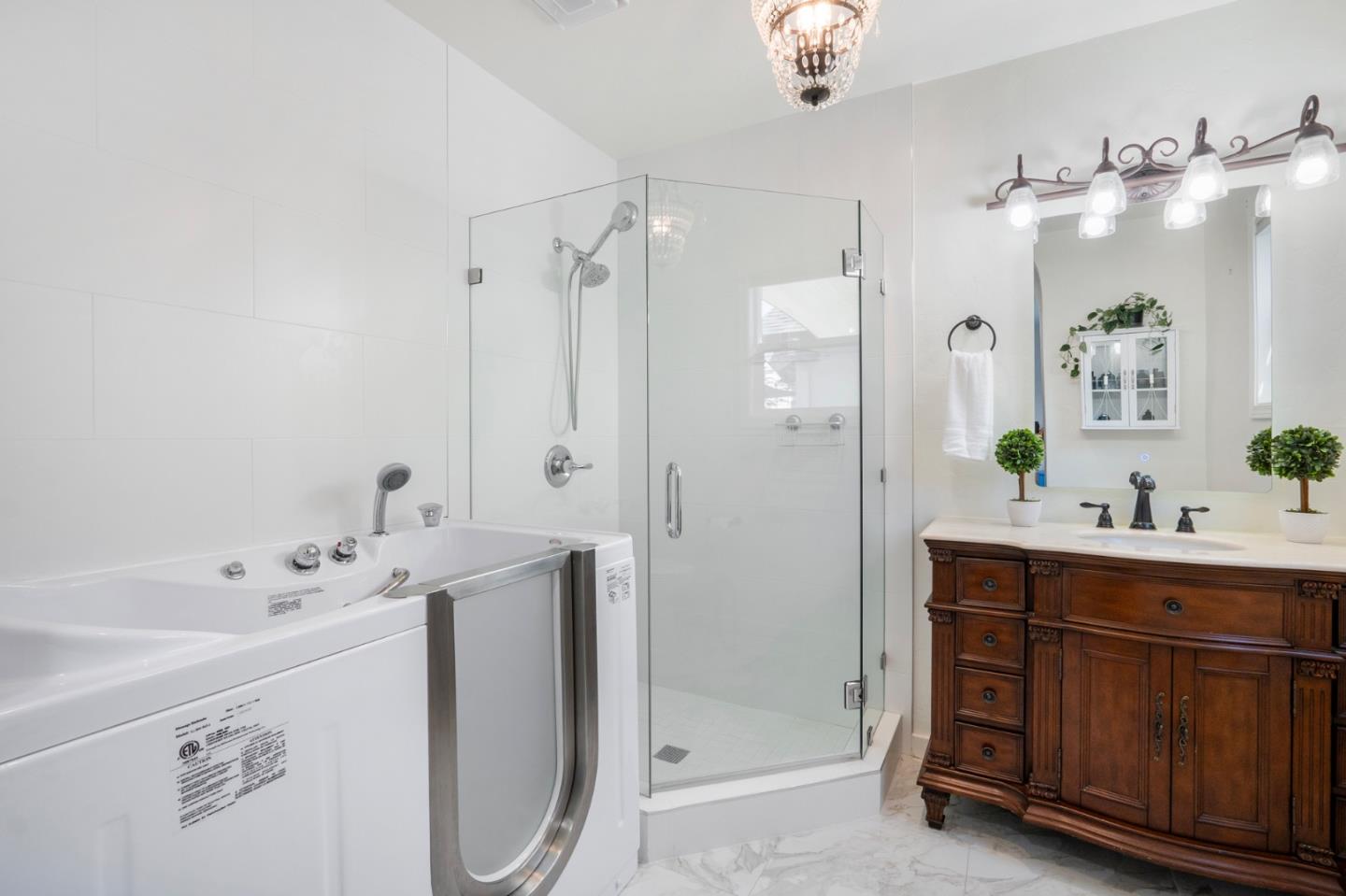 545 4th Street Gilroy, CA 95020 - Photo 19 of 36 a spacious bathroom with a double vanity sink mirror and bathtub