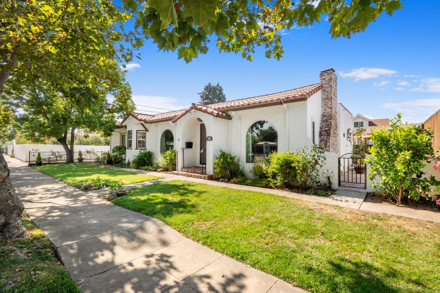 545 4th Street Gilroy, CA 95020 - Photo 2 of 36 a view of a white house with a big yard and large tree