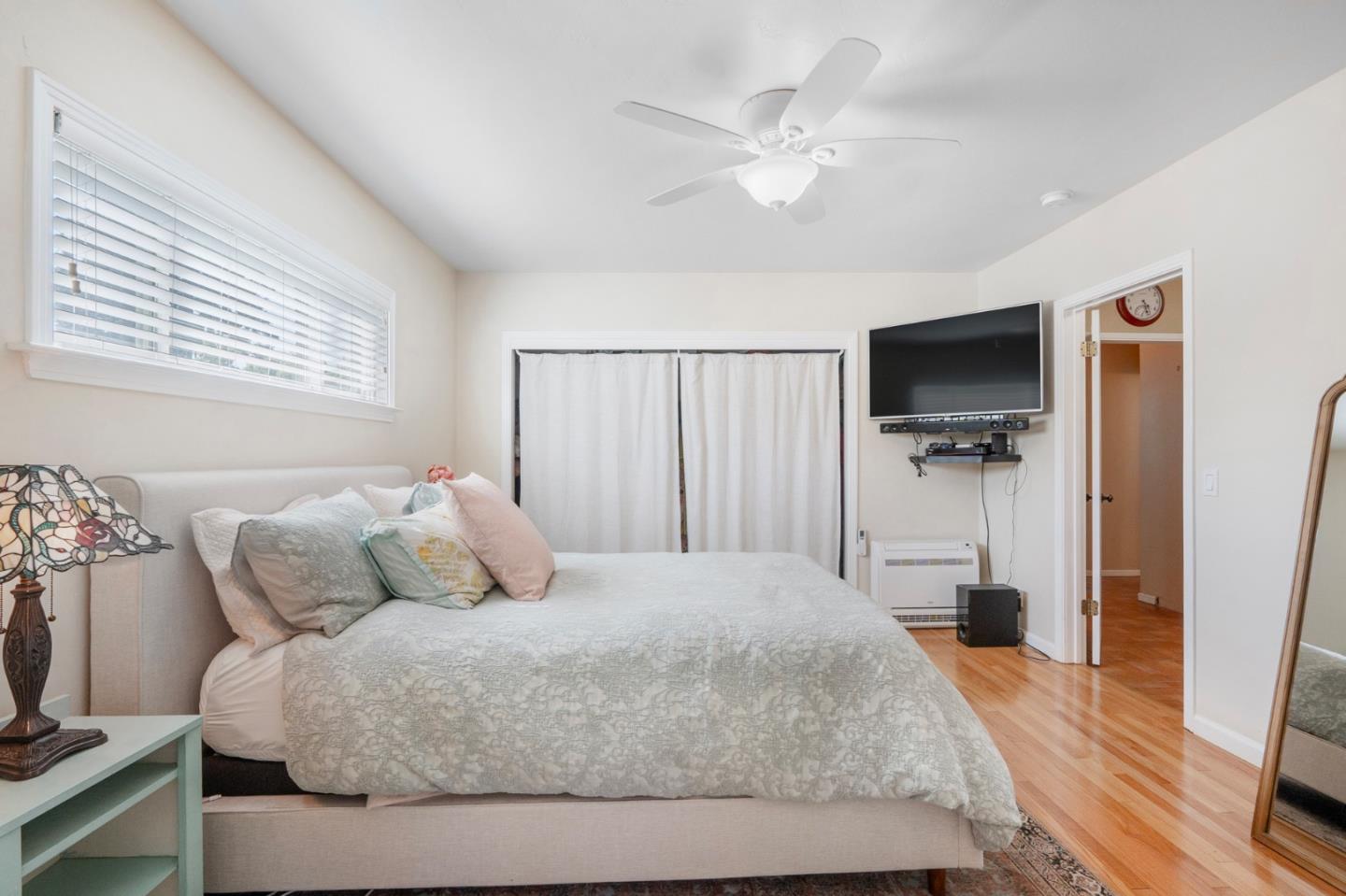 545 4th Street Gilroy, CA 95020 - Photo 21 of 36 a bedroom with a bed and a flat screen tv