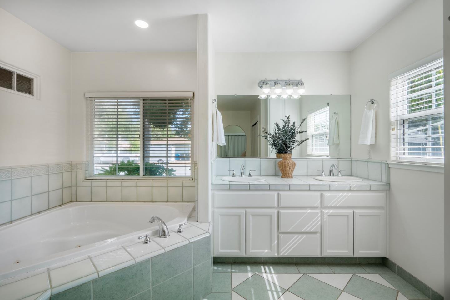 545 4th Street Gilroy, CA 95020 - Photo 23 of 36 a bathroom with a bathtub sink and mirror