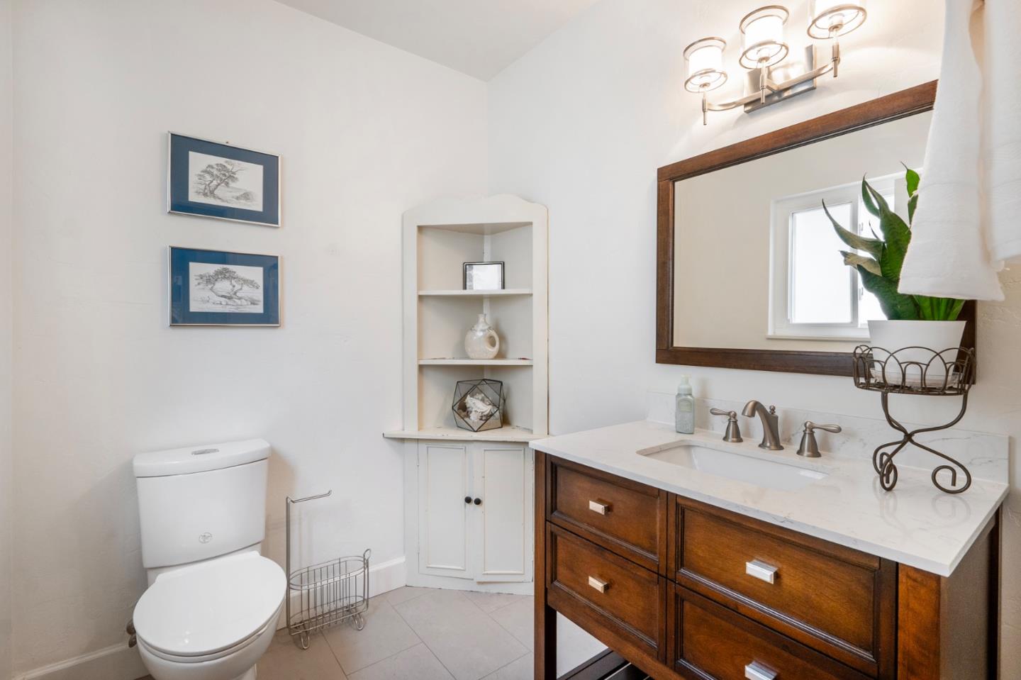 545 4th Street Gilroy, CA 95020 - Photo 27 of 36 a bathroom with a toilet a sink and mirror