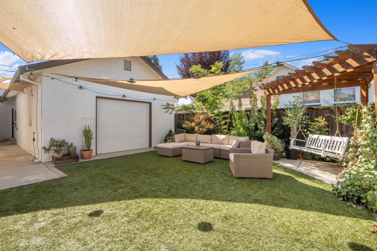545 4th Street Gilroy, CA 95020 - Photo 32 of 36 a view of a patio with table and chairs potted plants