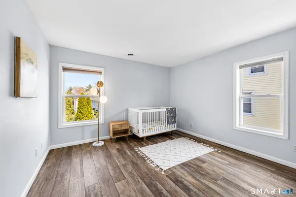 a view of room with window and wooden floor
