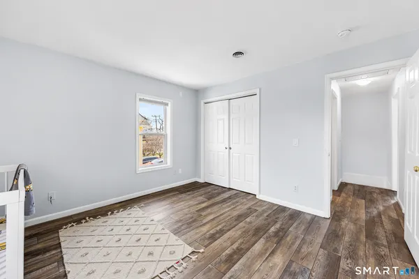 a view of an empty room and wooden floor
