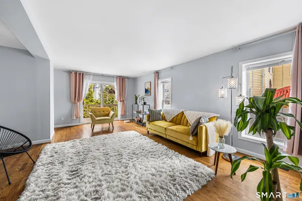 a living room with furniture and a potted plant